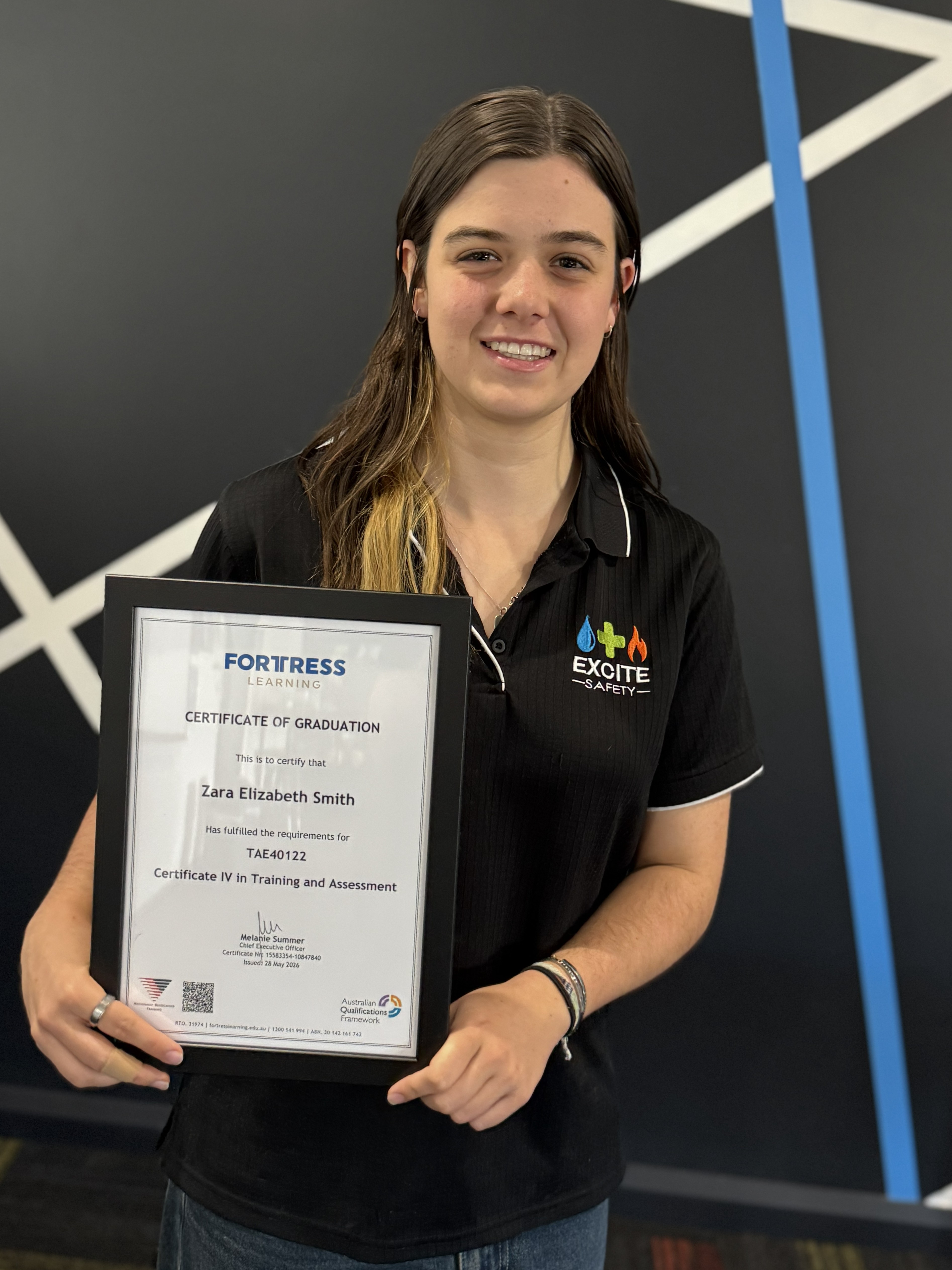 Newly Qualified Trainer Young trainer holding her Certificate IV in training and assessment